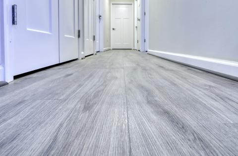 Duravana 'Silk Spire Oak' waterproof flooring installed throughout halls and living area.